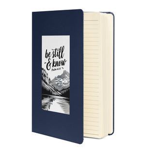 Be Still and Know journal, navy cover partly open.