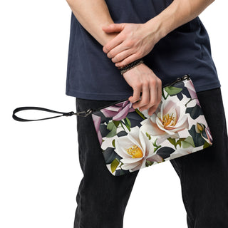 Bed of Roses crossbody bag with cream flowers, purple roses and black trim; used as a wristlet.