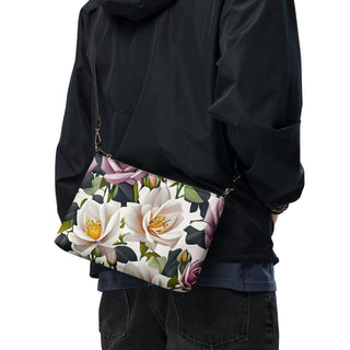 Bed of Roses crossbody bag with cream flowers, purple roses and black trim; worn across a black outfit.