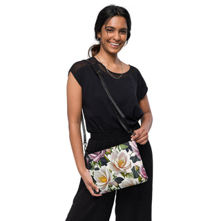 Woman wearing the Bed of Roses floral crossbody bag with a black outfit.