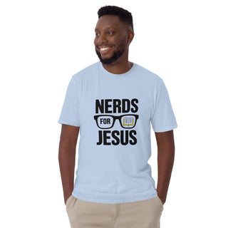 A smiling man wearing a light blue graphic t-shirt with the text 'NERDS FOR JESUS' and a glasses/book design, paired with khaki pants, against a plain white background.