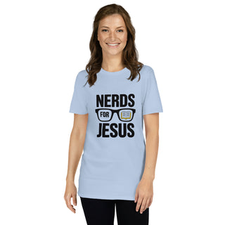 A woman modeling a light blue crewneck t-shirt with a black graphic that reads 'NERDS FOR JESUS' with glasses and a Bible illustration, set against a plain white background.