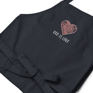Navy apron laid flat, showing floral heart embroidery and the words God Is Love.