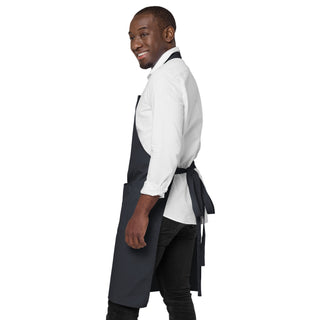 Side view of the navy God Is Love apron, showing its length and tied waist straps.