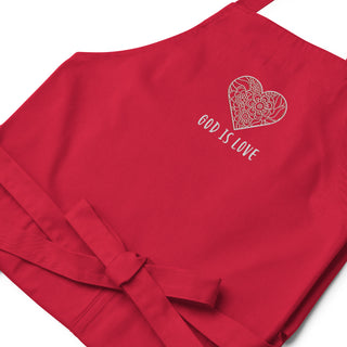 Red apron laid flat, showing floral heart embroidery and the words God Is Love.