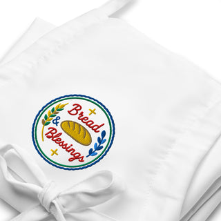 Bread & Blessings embroidered apron, white embroidery close-up.