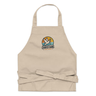 Beige Christians For Christ apron folded flat with its embroidered chest design and waist ties in a bow.