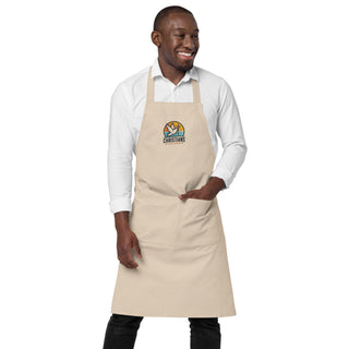 Man wearing the beige Christians For Christ apron with one hand in the front pocket.