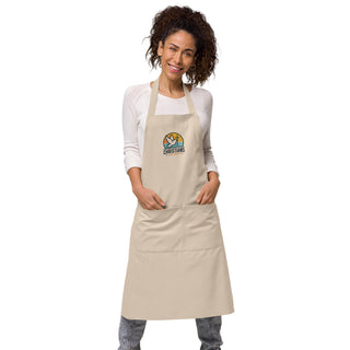 Woman wearing the beige Christians For Christ apron with both hands in its divided front pocket.