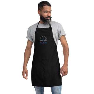 Jesus Saves embroidered apron with waves and a small boat design; black, full front on a bearded model.