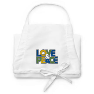 Love & Peace embroidered apron with blue, green, and yellow lettering, white apron folded.