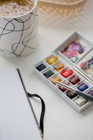 Art pallette and mug with coffee - ShellMiddy About Us Page