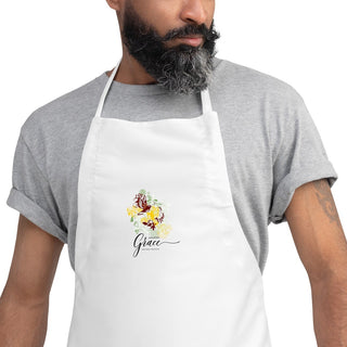 Close-up of the white Amazing Grace apron worn by a man.
