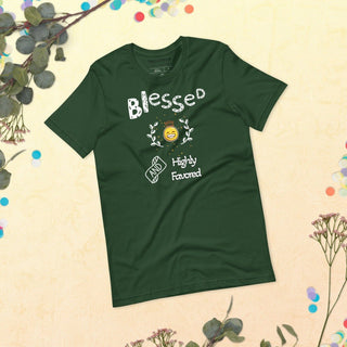 Green T-shirt with Blessed and Highly Favored lettering with a smiling sun, laid flat among flowers