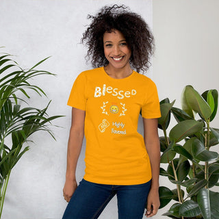 Yellow T-shirt with Blessed and Highly Favored lettering with a smiling sun, modeled beside plants