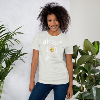 White T-shirt with Blessed and Highly Favored lettering with a smiling sun, modeled beside plants