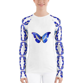 White long-sleeve rash guard with blue butterflies on the chest and sleeves, modeled with white pants, front view