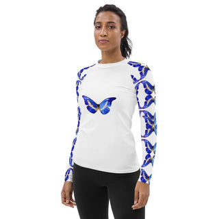 White long-sleeve rash guard with blue butterflies on the chest and sleeves, modeled at an angle