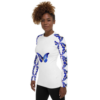 White long-sleeve rash guard with blue butterflies on the chest and sleeves, modeled at a side angle