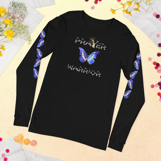 Black long-sleeve T-shirt with Prayer Warrior lettering and blue butterfly design, laid flat among flowers