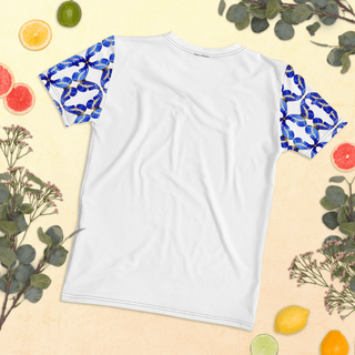 Back of white T-shirt laid flat among fruit and leaves, showing blue butterfly sleeves