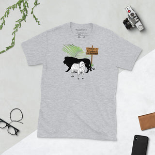 Light gray T-shirt with The King Is Coming lion, lamb and palm design, laid flat beside a camera and glasses